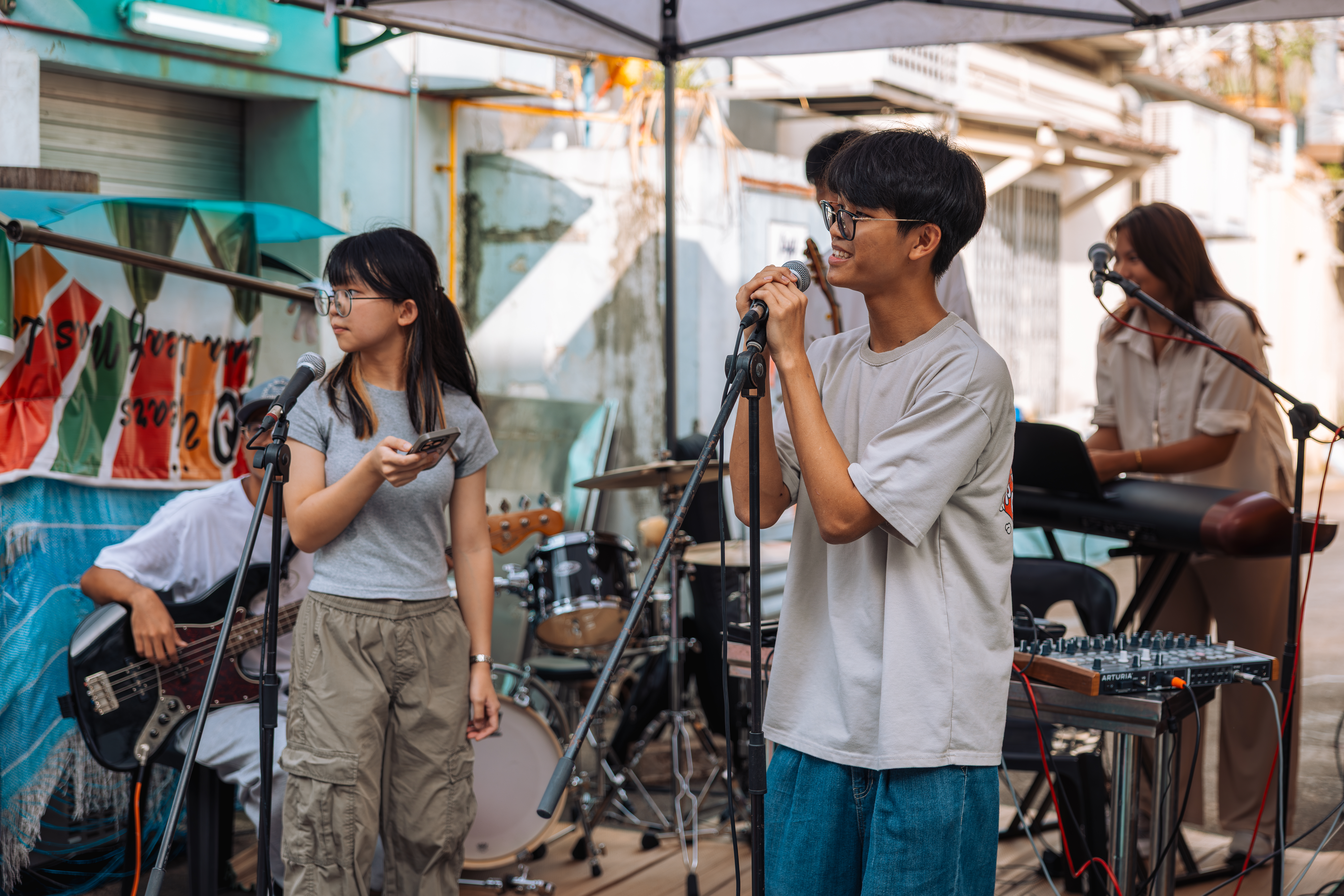 Young performers singing at an outdoor Amplify jam